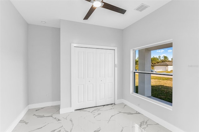 unfurnished bedroom featuring a closet and ceiling fan