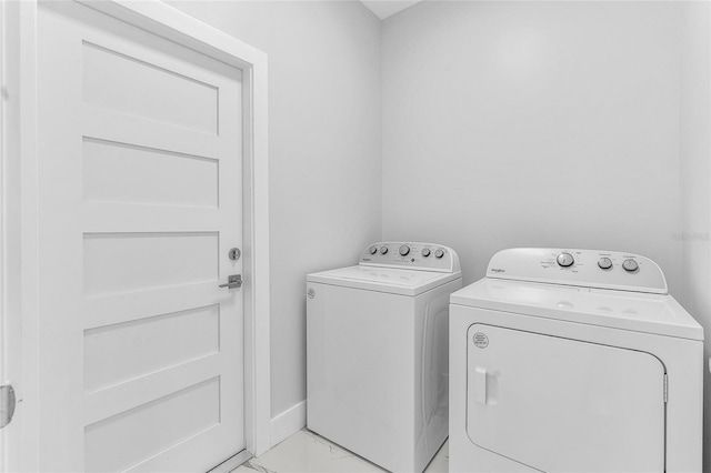 laundry area with independent washer and dryer