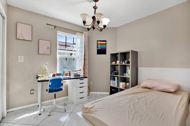 bedroom with an inviting chandelier, light tile patterned flooring, and a textured ceiling