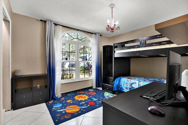 bedroom featuring an inviting chandelier, light tile patterned floors, and a textured ceiling