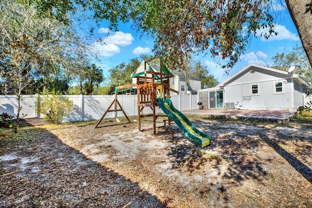 view of playground with cooling unit and a patio area