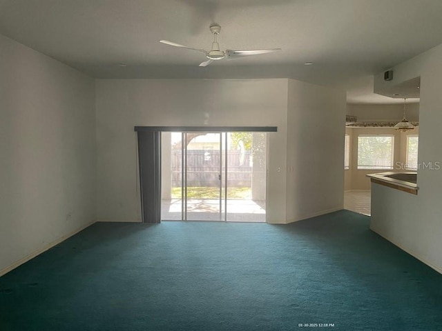 unfurnished room with ceiling fan, a healthy amount of sunlight, and carpet flooring