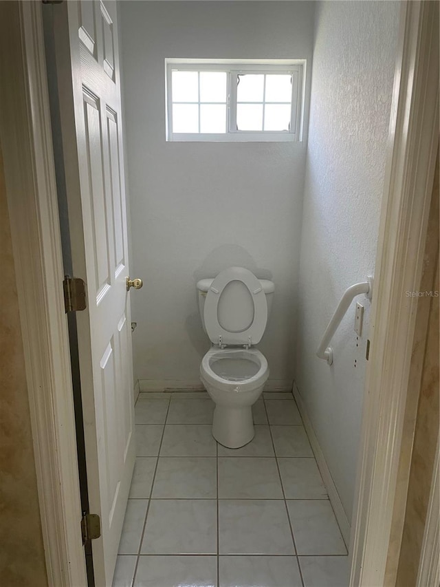 bathroom featuring tile patterned floors and toilet