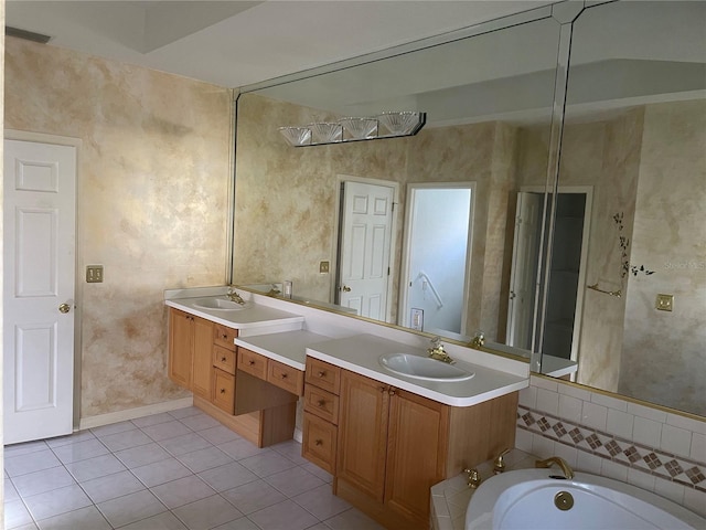 bathroom with vanity, tile patterned floors, and a tub