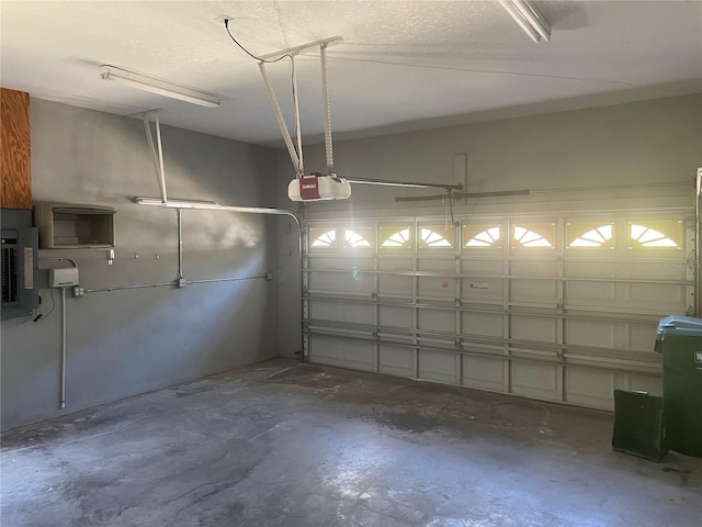 garage featuring a garage door opener and electric panel