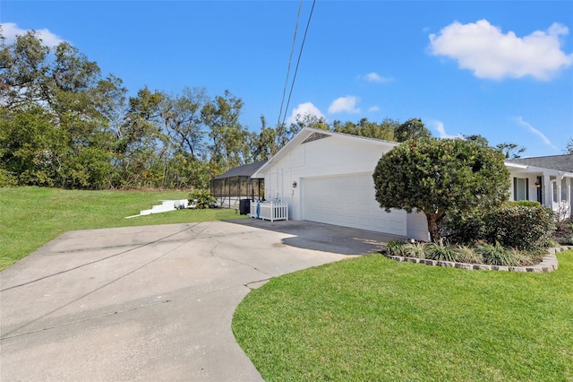 view of side of property with a garage and a lawn