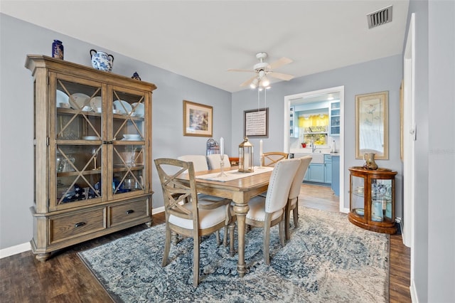 dining area featuring dark hardwood / wood-style floors and ceiling fan