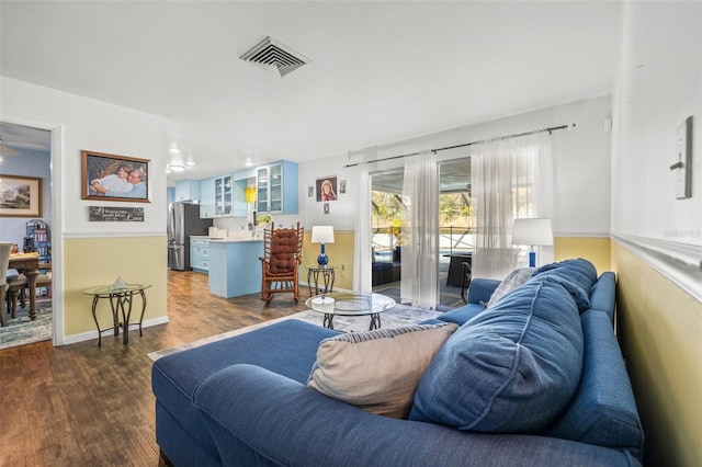 living room with dark wood-type flooring and sink