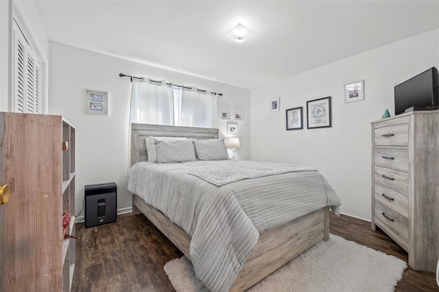 bedroom with dark hardwood / wood-style flooring