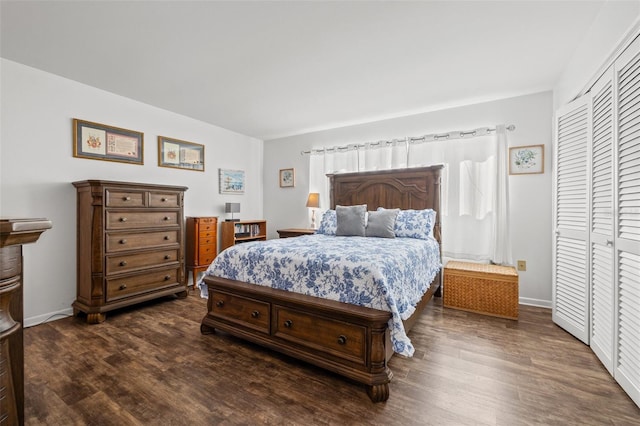 bedroom with dark wood-type flooring and a closet