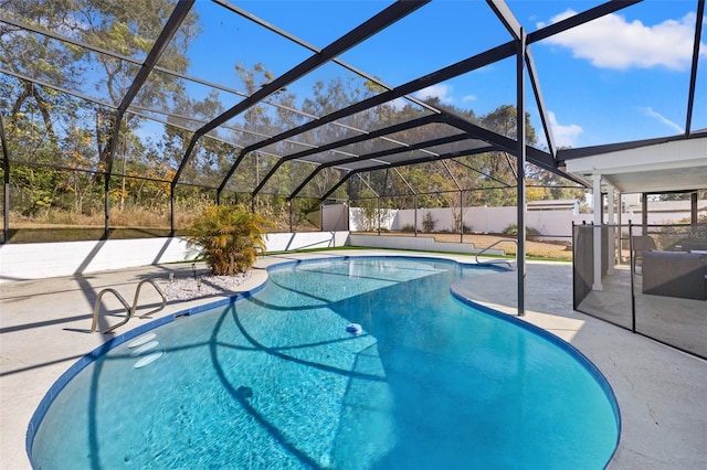 view of swimming pool featuring a patio and glass enclosure