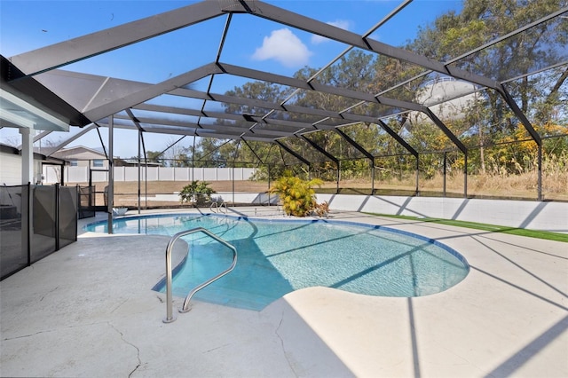 view of swimming pool featuring a lanai and a patio area