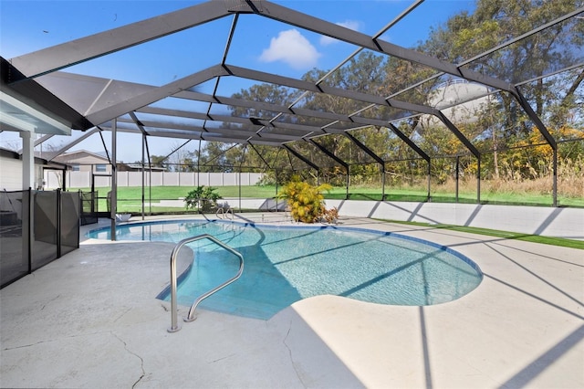 view of pool featuring glass enclosure and a patio area