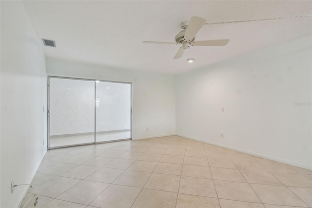 spare room featuring light tile patterned flooring and ceiling fan