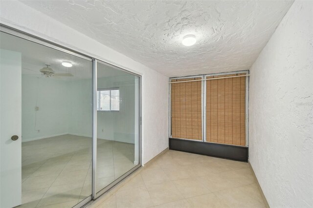 interior space featuring ceiling fan and a textured ceiling