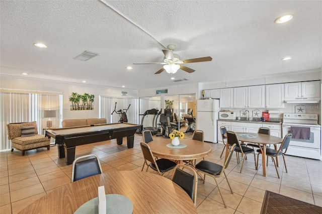 recreation room featuring light tile patterned floors, sink, ceiling fan, a textured ceiling, and pool table