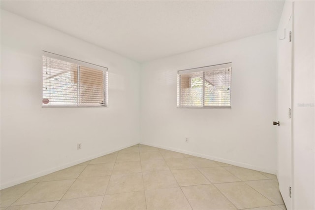 spare room with light tile patterned floors