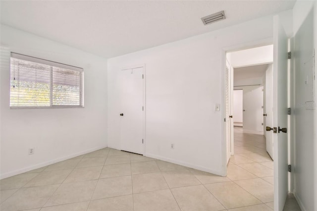 unfurnished bedroom featuring light tile patterned floors