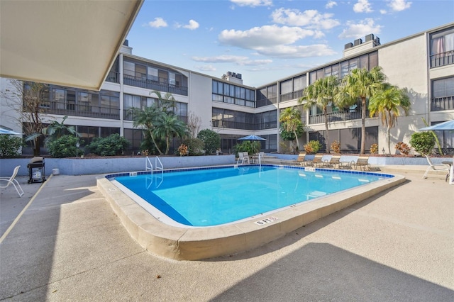 view of swimming pool featuring a patio area