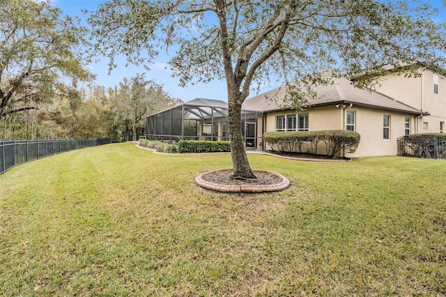 view of yard featuring a fenced backyard and a lanai