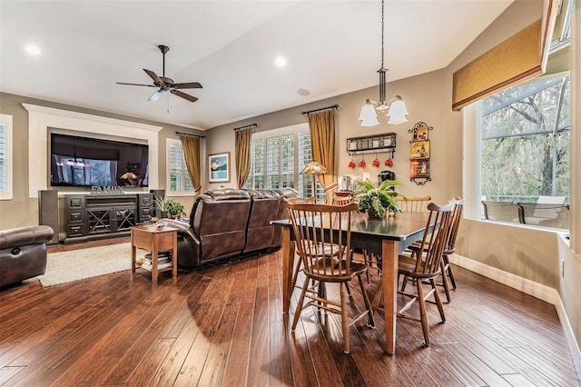 dining space with recessed lighting, baseboards, dark wood finished floors, and ceiling fan with notable chandelier