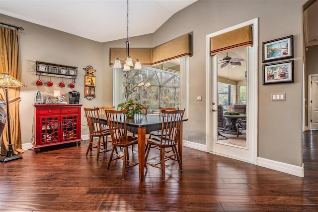 dining room with baseboards, vaulted ceiling, hardwood / wood-style floors, and ceiling fan with notable chandelier