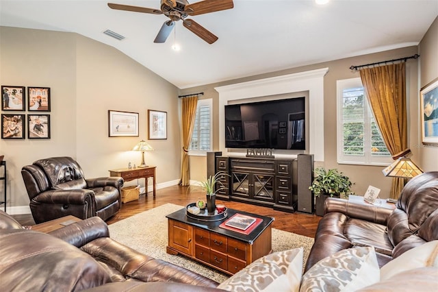 living room with visible vents, vaulted ceiling, baseboards, and wood finished floors