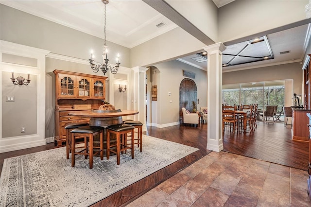 dining area with ornate columns, baseboards, visible vents, and crown molding