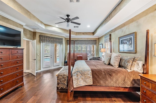 bedroom with access to outside, a tray ceiling, dark wood-type flooring, and crown molding