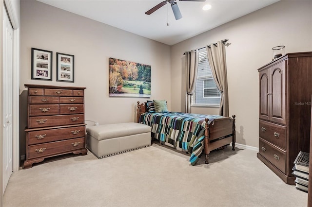 bedroom featuring baseboards, a ceiling fan, and light colored carpet