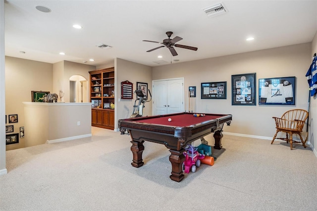 game room featuring arched walkways, recessed lighting, visible vents, and light colored carpet