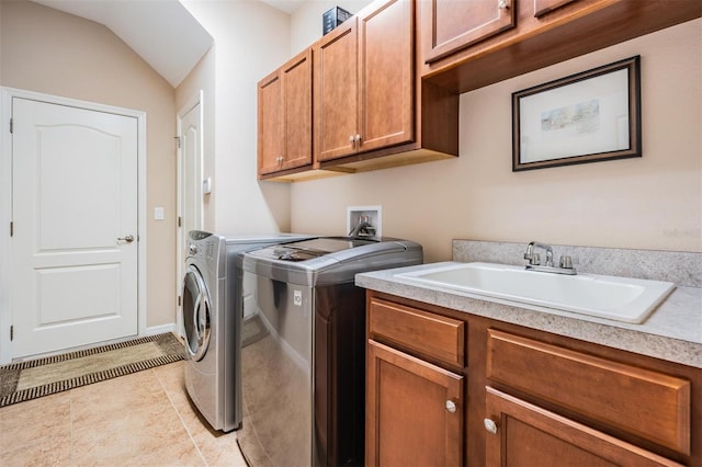 washroom featuring washer and dryer, cabinet space, a sink, and light tile patterned floors