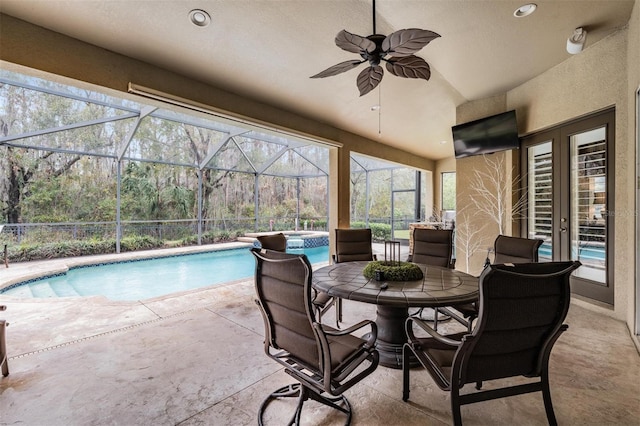 exterior space featuring a ceiling fan, a lanai, and a pool with connected hot tub