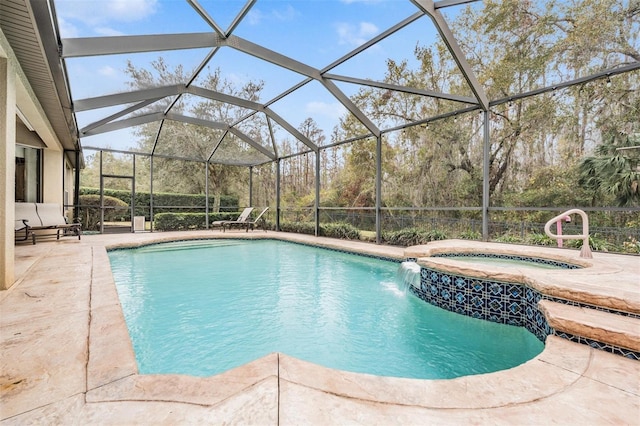 outdoor pool featuring glass enclosure, a patio, and an in ground hot tub