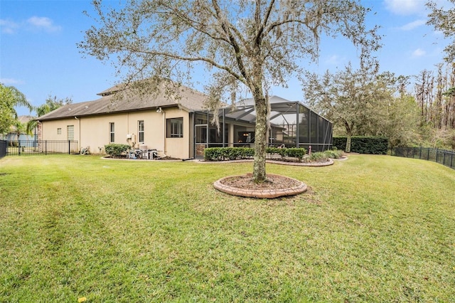 view of yard with a lanai and a fenced backyard