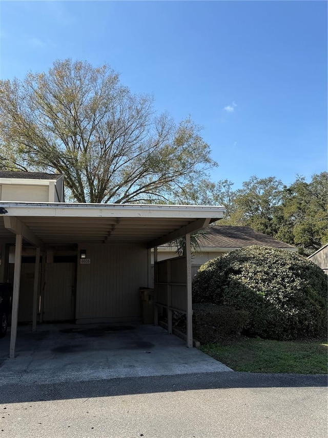 view of parking / parking lot featuring a carport