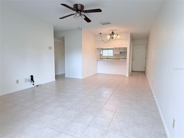 spare room with light tile patterned flooring and ceiling fan with notable chandelier