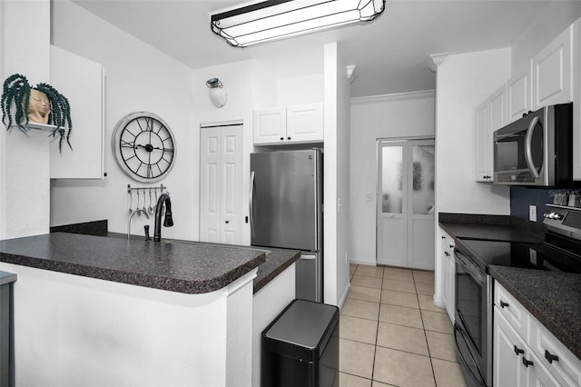 kitchen with a breakfast bar area, white cabinetry, light tile patterned floors, kitchen peninsula, and stainless steel appliances