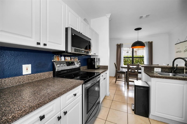 kitchen featuring white cabinetry, sink, hanging light fixtures, and appliances with stainless steel finishes