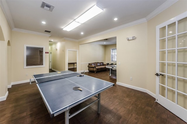 recreation room featuring ornamental molding and dark hardwood / wood-style floors