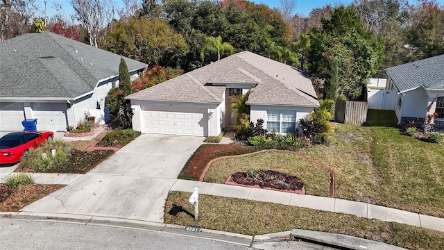 view of front of property featuring a garage and a front lawn