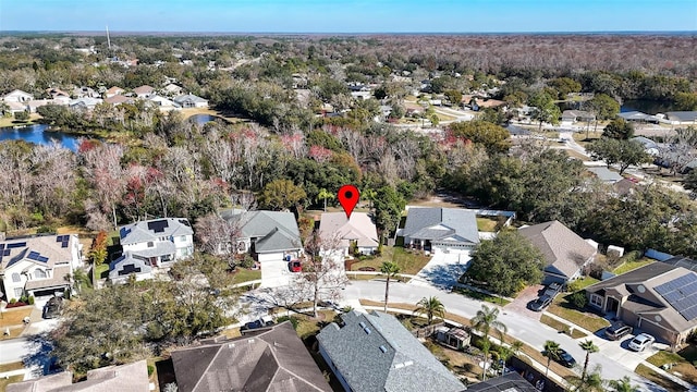 drone / aerial view featuring a residential view and a water view