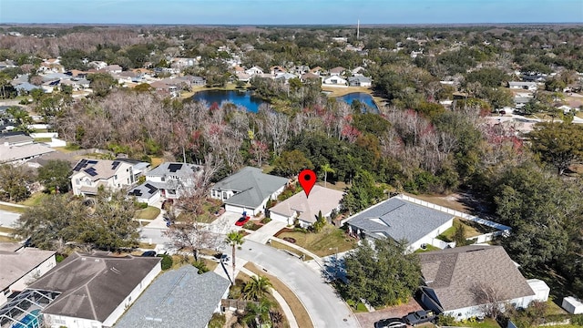 drone / aerial view with a water view and a residential view