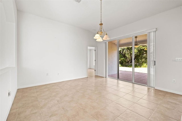 unfurnished room featuring baseboards and a chandelier