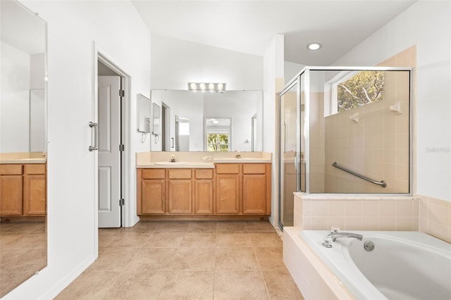 full bath featuring double vanity, a stall shower, a garden tub, and a sink