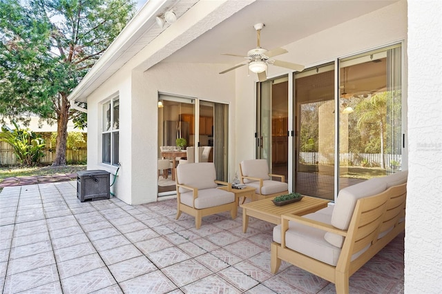 view of patio / terrace with fence and a ceiling fan