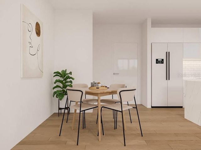 dining space with light wood-type flooring