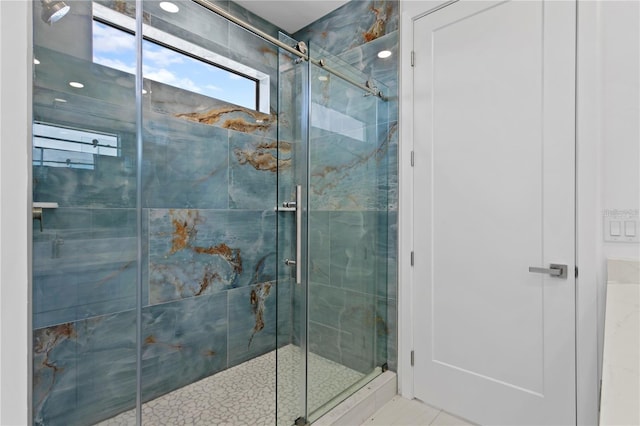 bathroom featuring a shower with door