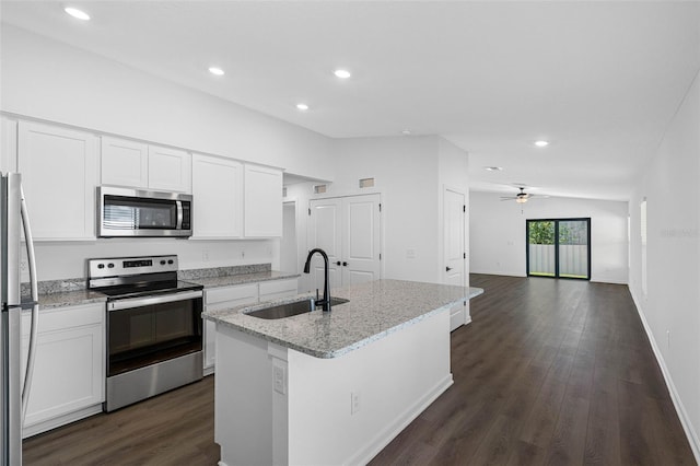 kitchen with a kitchen island with sink, sink, light stone counters, and stainless steel appliances