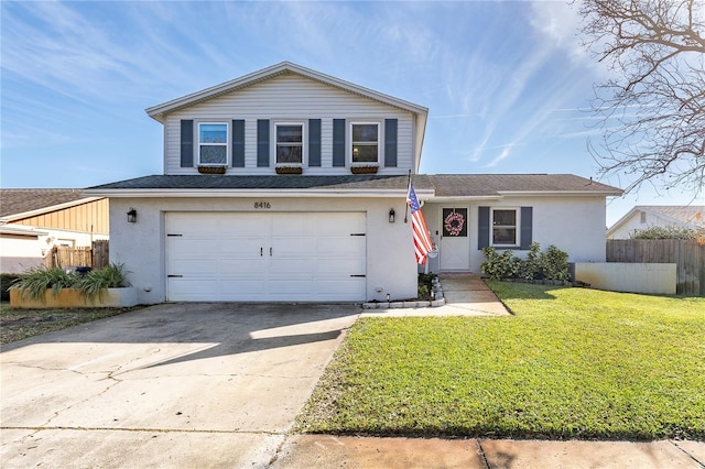 view of front property featuring a garage and a front lawn